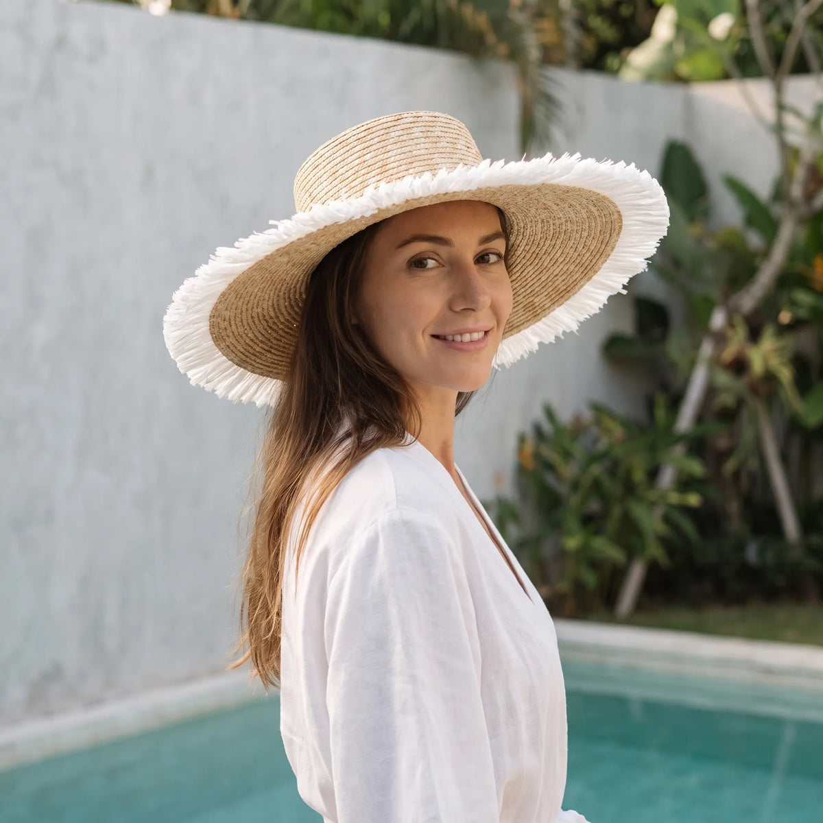Wide brim woven sun hat with black ribbon detail for beach and outdoor wear