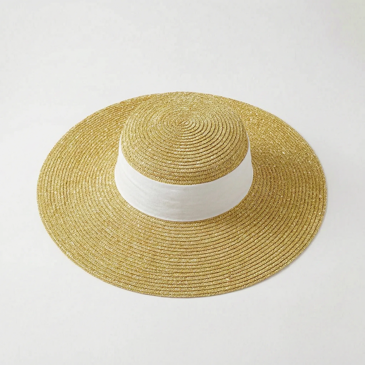 Wide brim woven sun hat with black ribbon detail for beach and outdoor wear