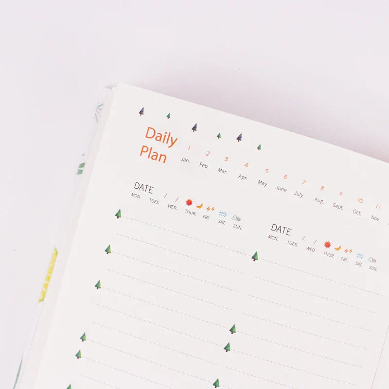 Compact daily planner notebook with colourful illustrated pages