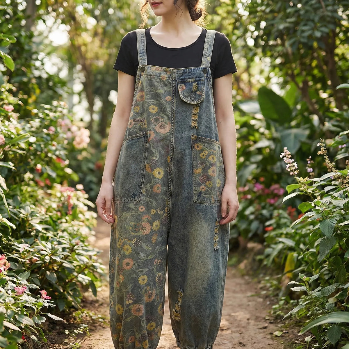 Denim dungaree with large-scale floral print and wide tapered leg