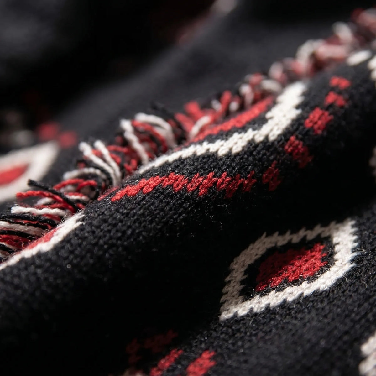 Fringed knit cardigan with geometric jacquard pattern and tie belt