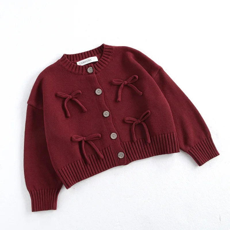 Girls knit cardigan with playful bows and ribbed details