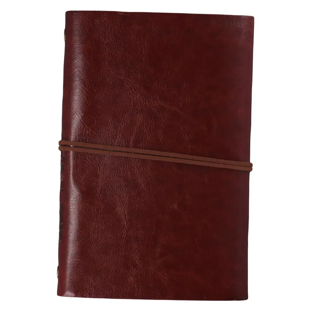Compact ring-bound journal with embossed leaf cover and vintage pendant closure