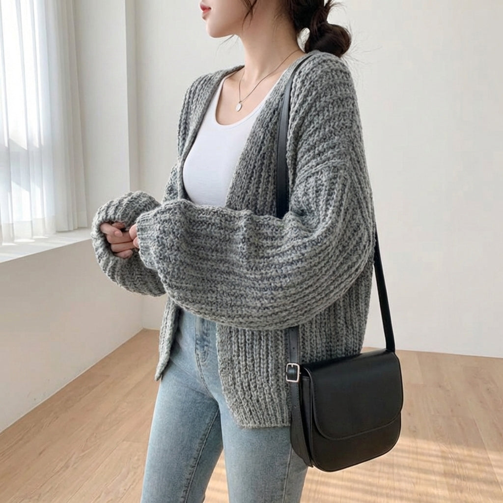 Oversized lantern sleeve cardigan with textured ribbed knit and dropped shoulders
