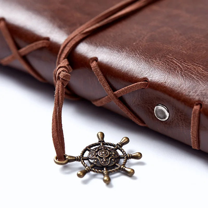 Compact refillable travel journal with vintage embossed compass design