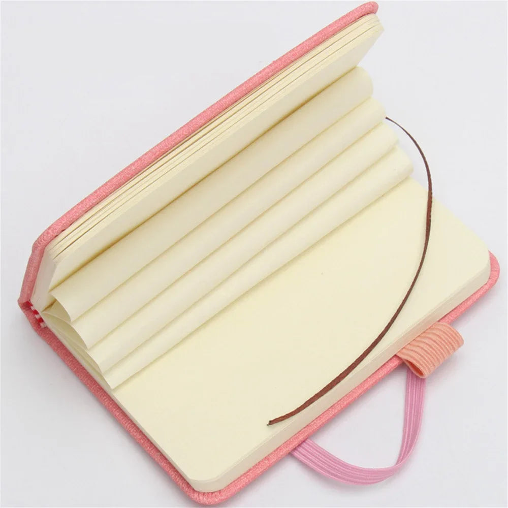 A7 portable coil notebook with blank pages and elastic closure