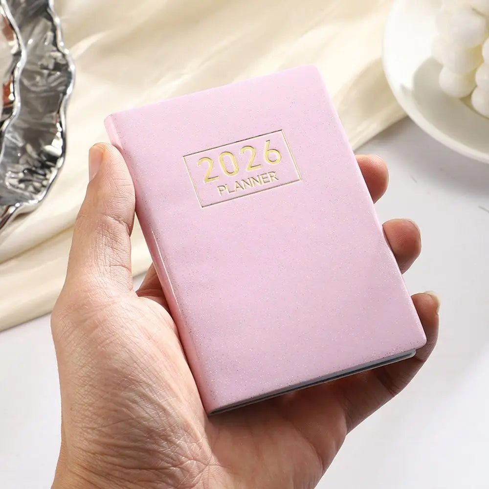 Compact pocket weekly planner with dated pages and mini calendars