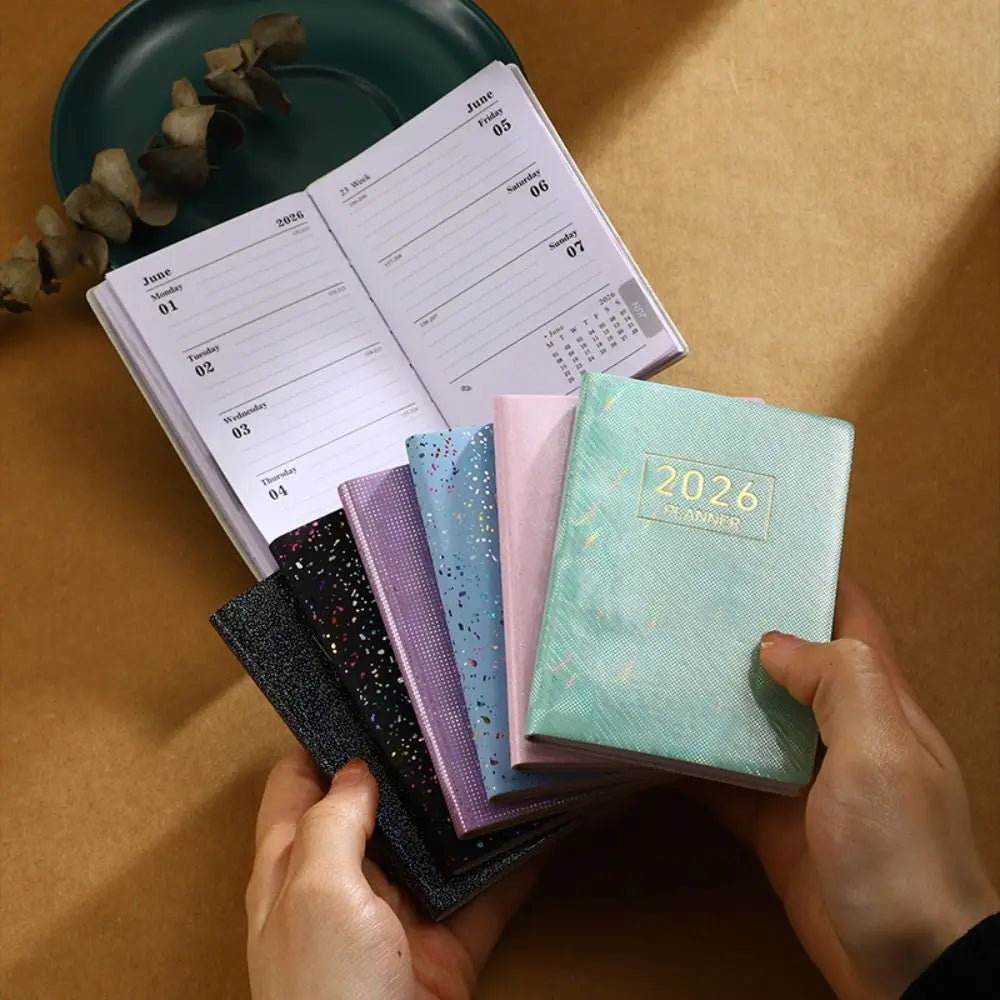 Compact pocket weekly planner with dated pages and mini calendars