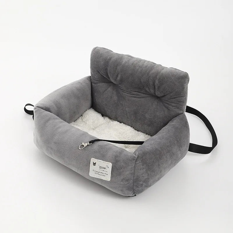 Padded pet car seat with raised backrest and non-slip underside