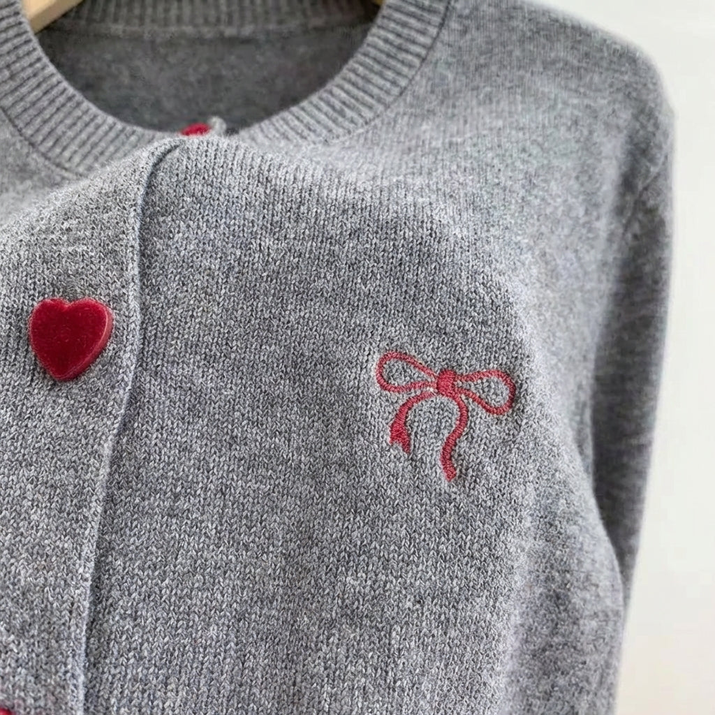 Women's cardigan with heart-shaped buttons and embroidered bow detail