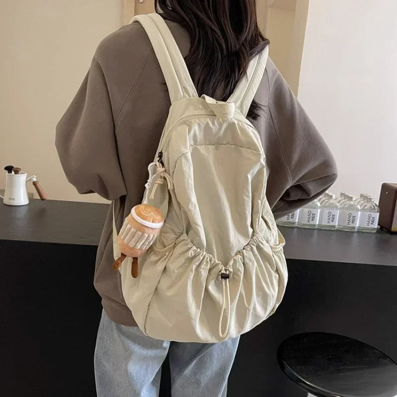 Large-volume nylon backpack with pleated design and padded straps