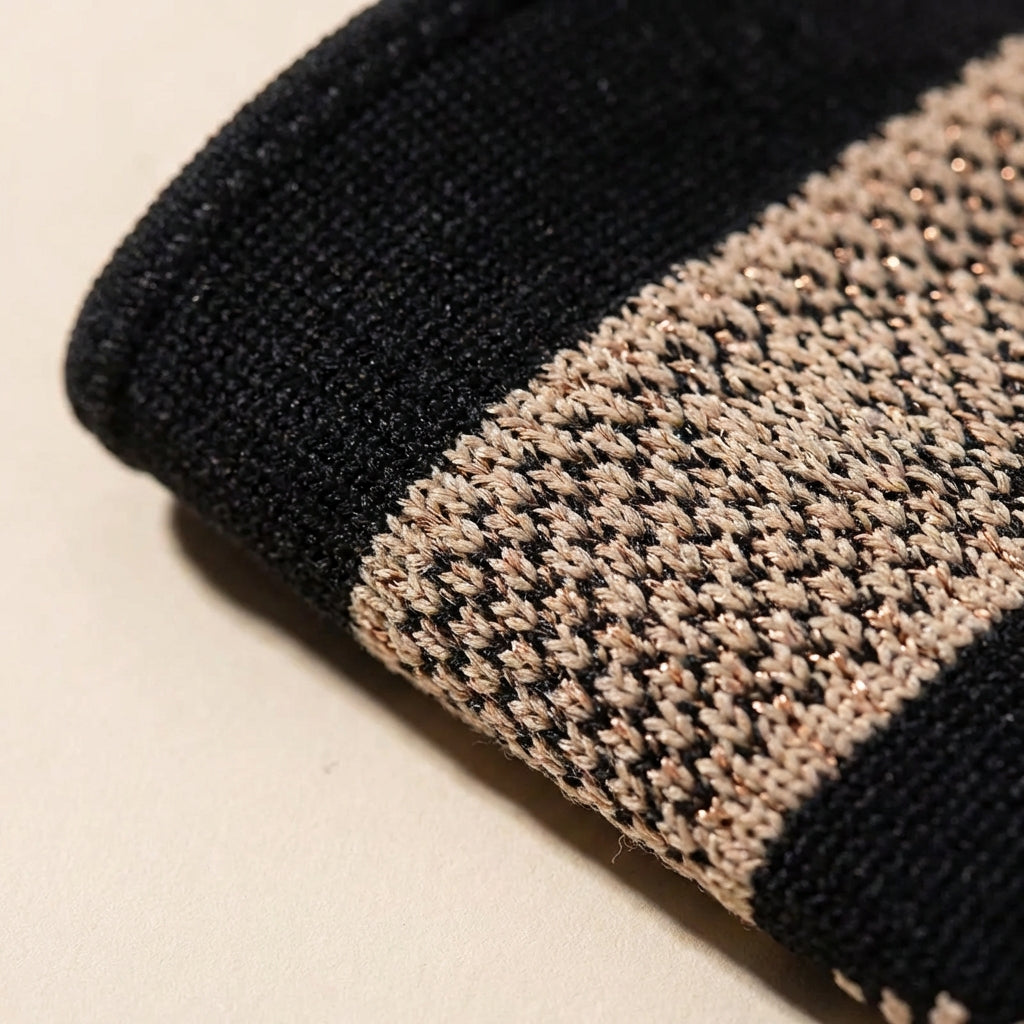 Compression wrist sleeve with targeted thumb support and reinforced band
