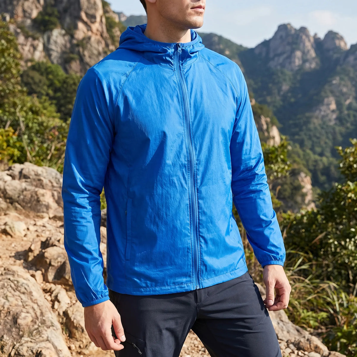 Lightweight packable windbreaker with integrated hood and water-repellent outer