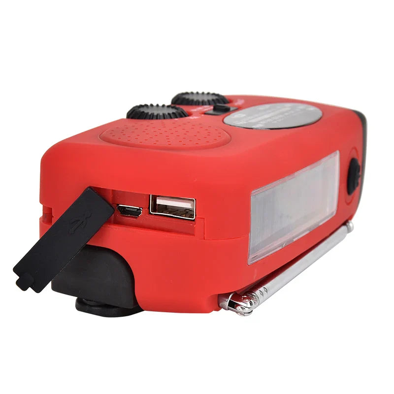 Portable emergency radio with hand crank solar charging and LED torch