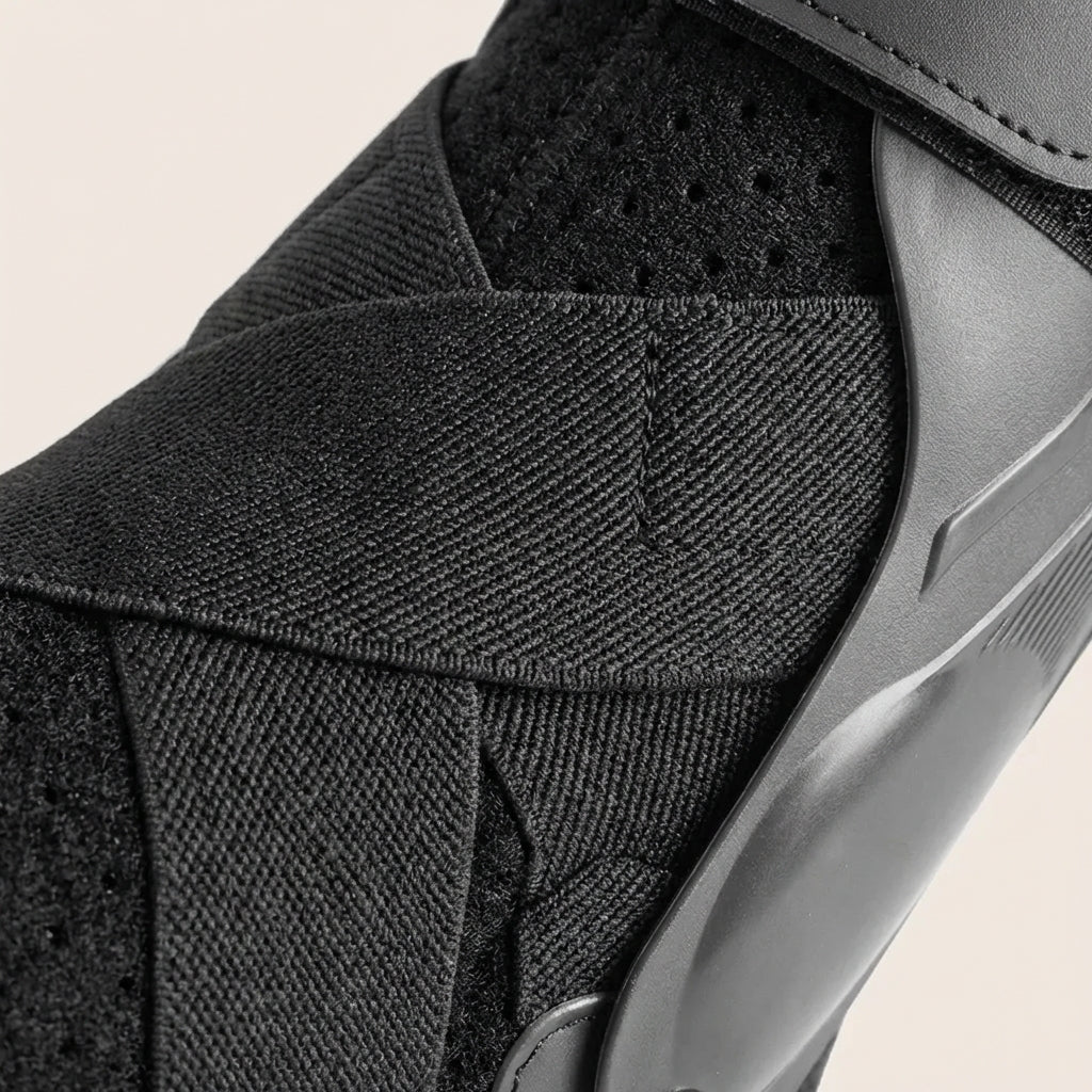 Adjustable ankle support brace with stabilising straps and breathable design