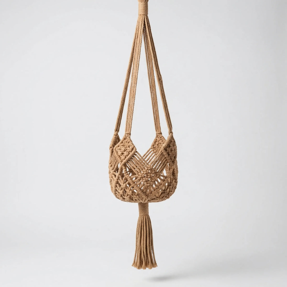 Boho macrame woven plant hanger with geometric knotted design and tassel finish