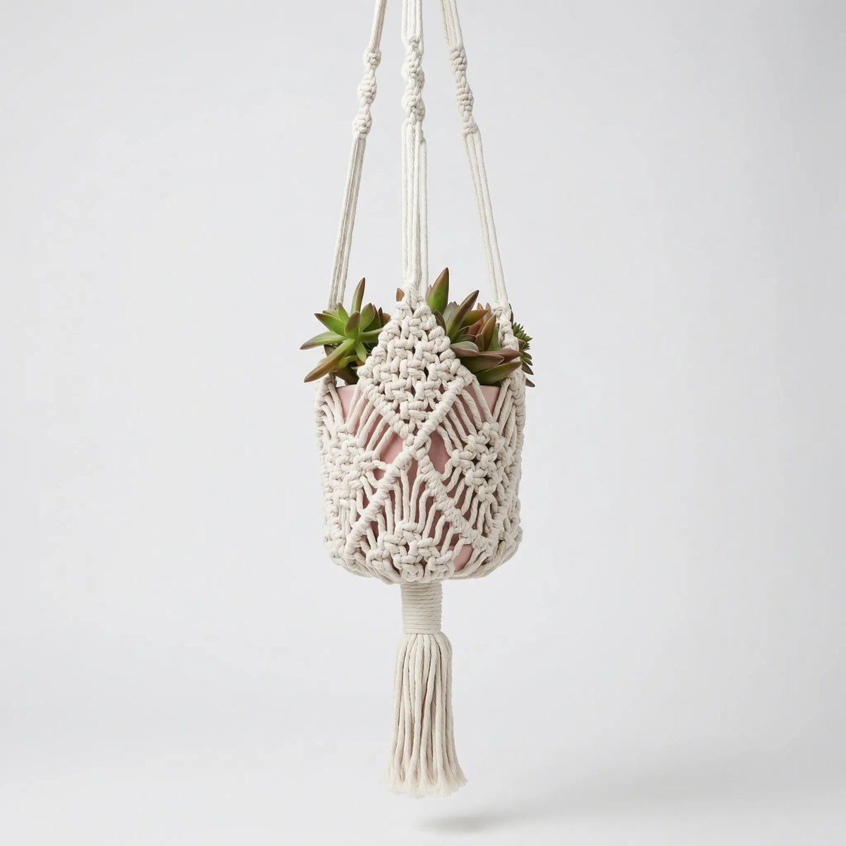 Boho macrame woven plant hanger with geometric knotted design and tassel finish