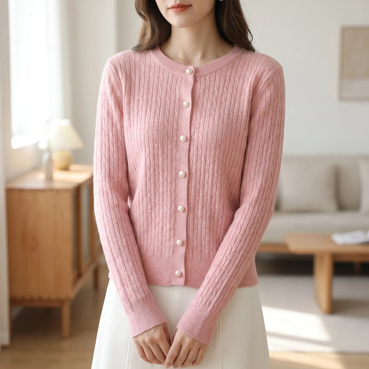 Women's cable knit cardigan with pearl-style buttons and ribbed details