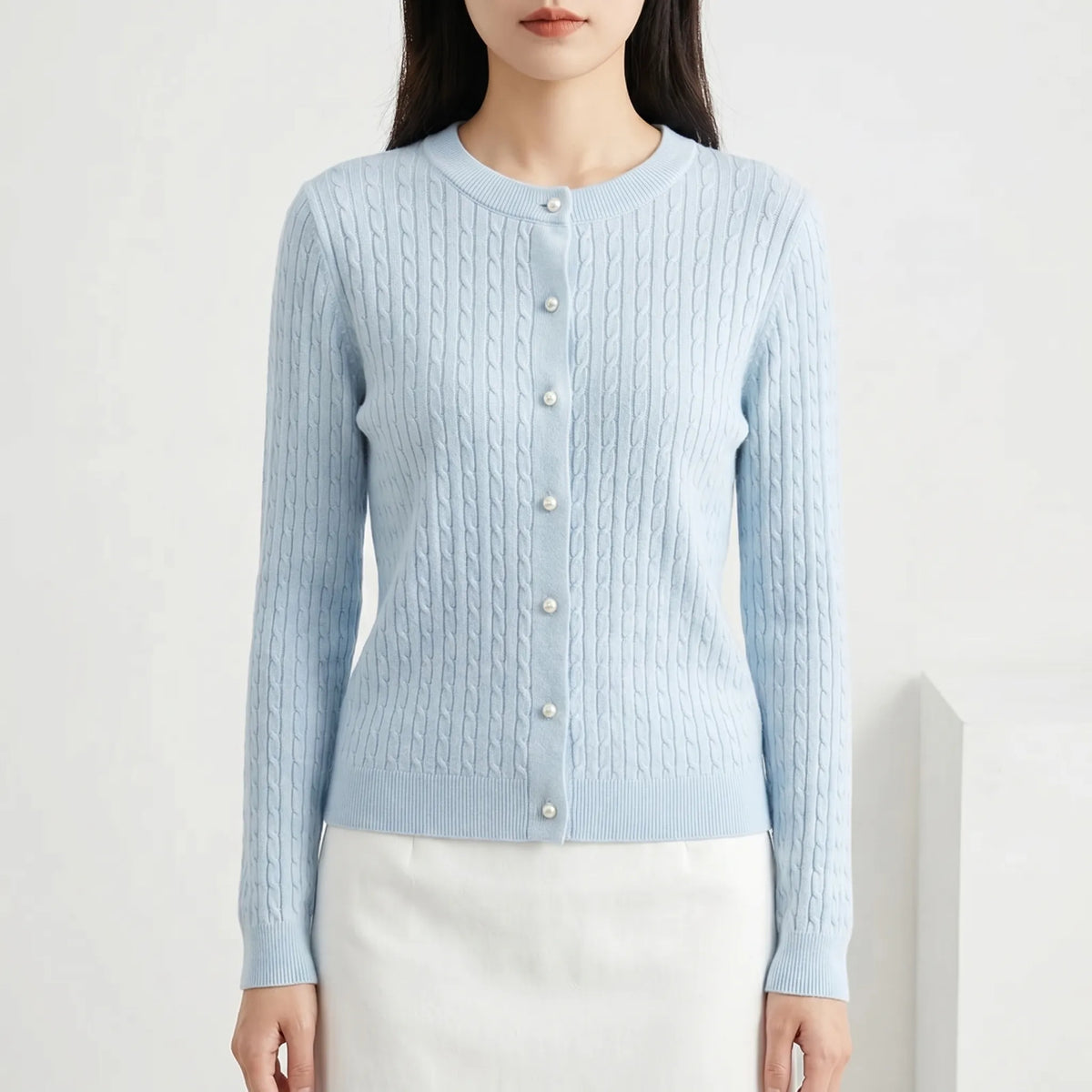Women's cable knit cardigan with pearl-style buttons and ribbed details