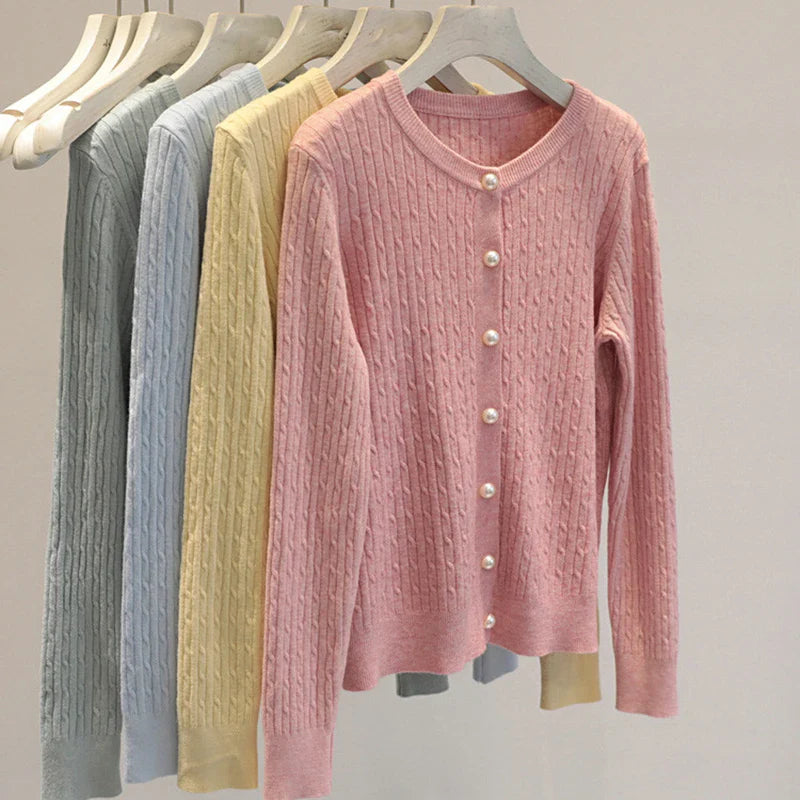 Women's cable knit cardigan with pearl-style buttons and ribbed details