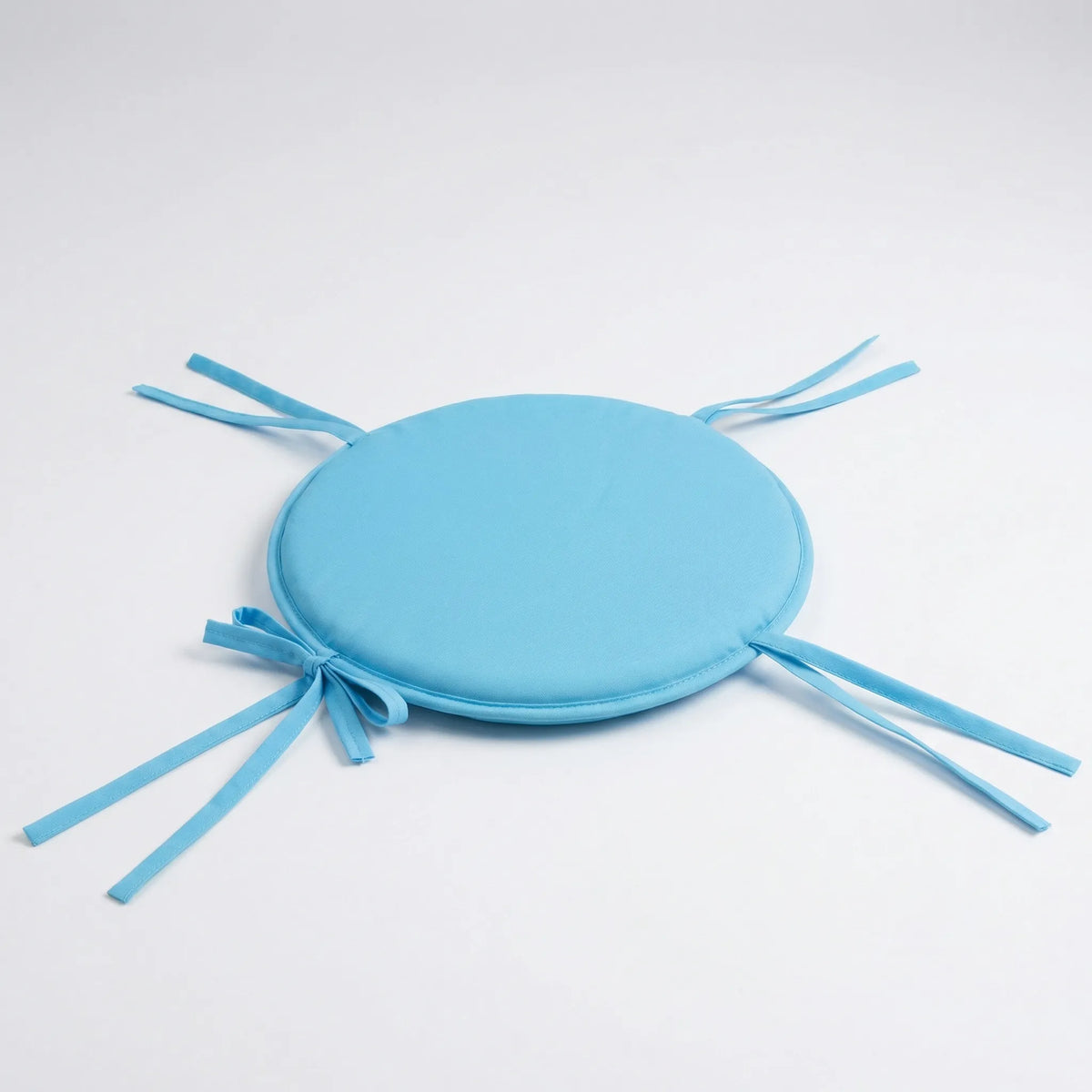 Round seat pad with attachment straps for dining and garden chairs