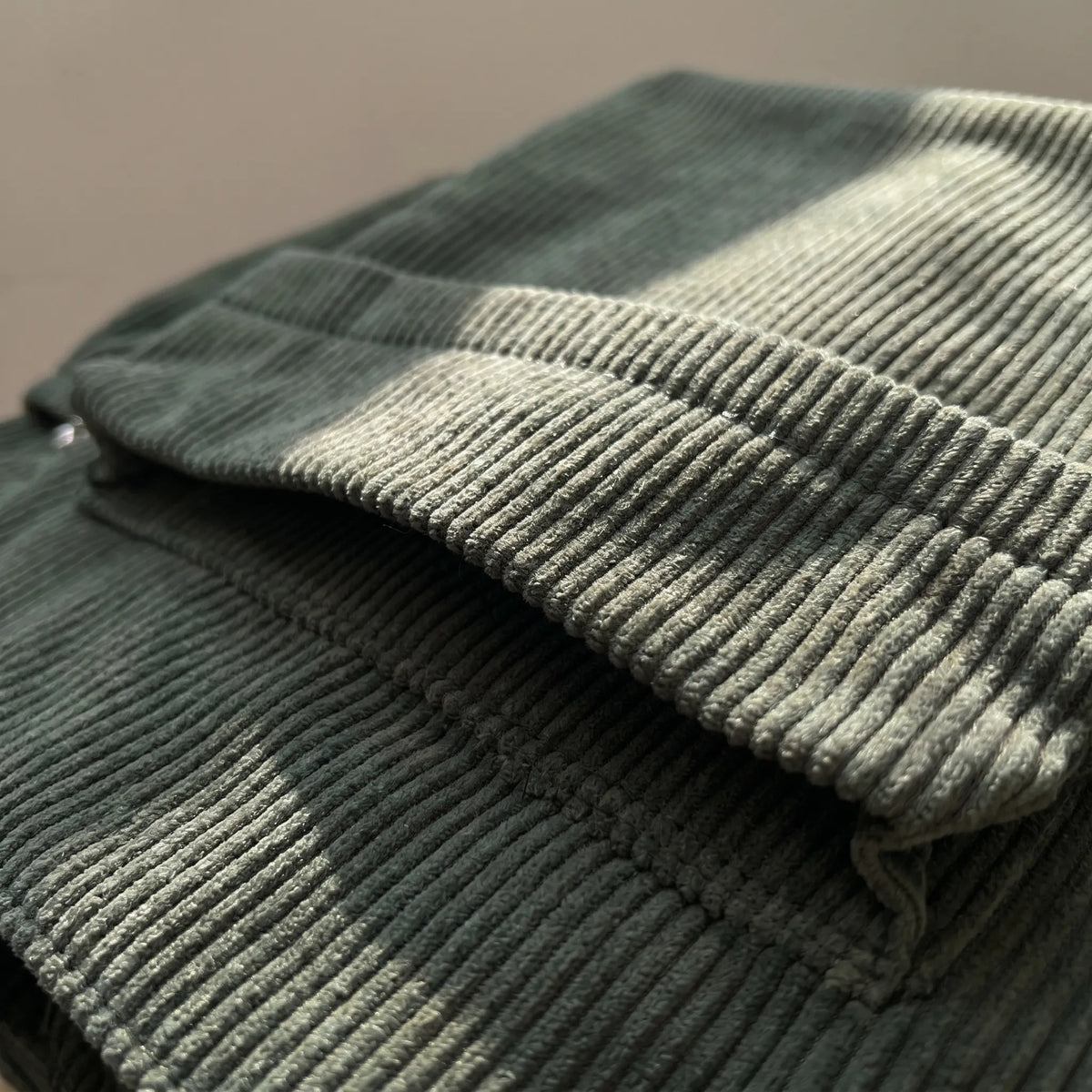 Corduroy shoulder tote with multiple external pockets and rope details
