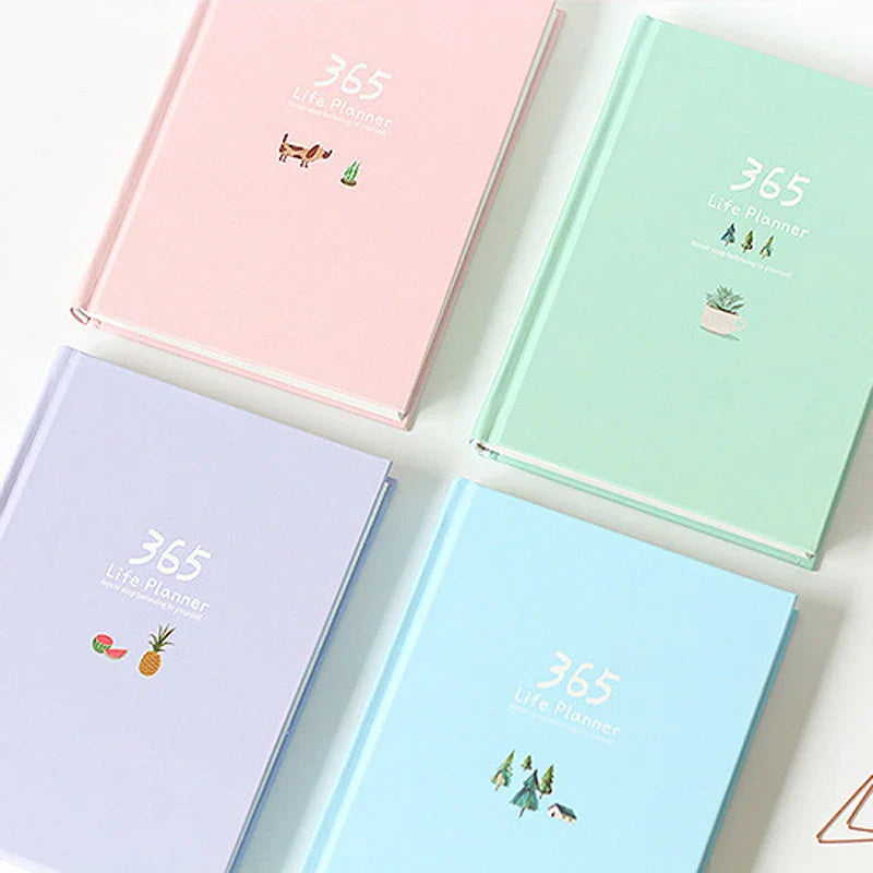 Compact daily planner notebook with colourful illustrated pages