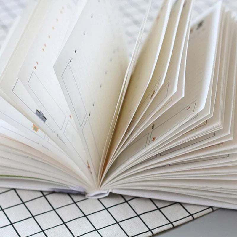 Compact daily planner notebook with colourful illustrated pages