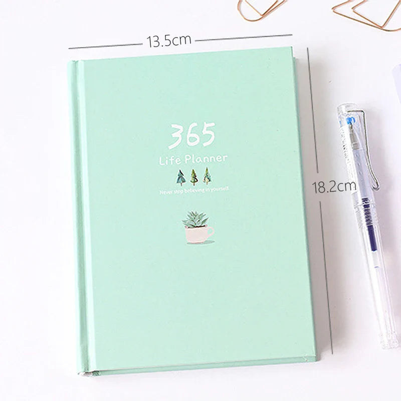 Compact daily planner notebook with colourful illustrated pages