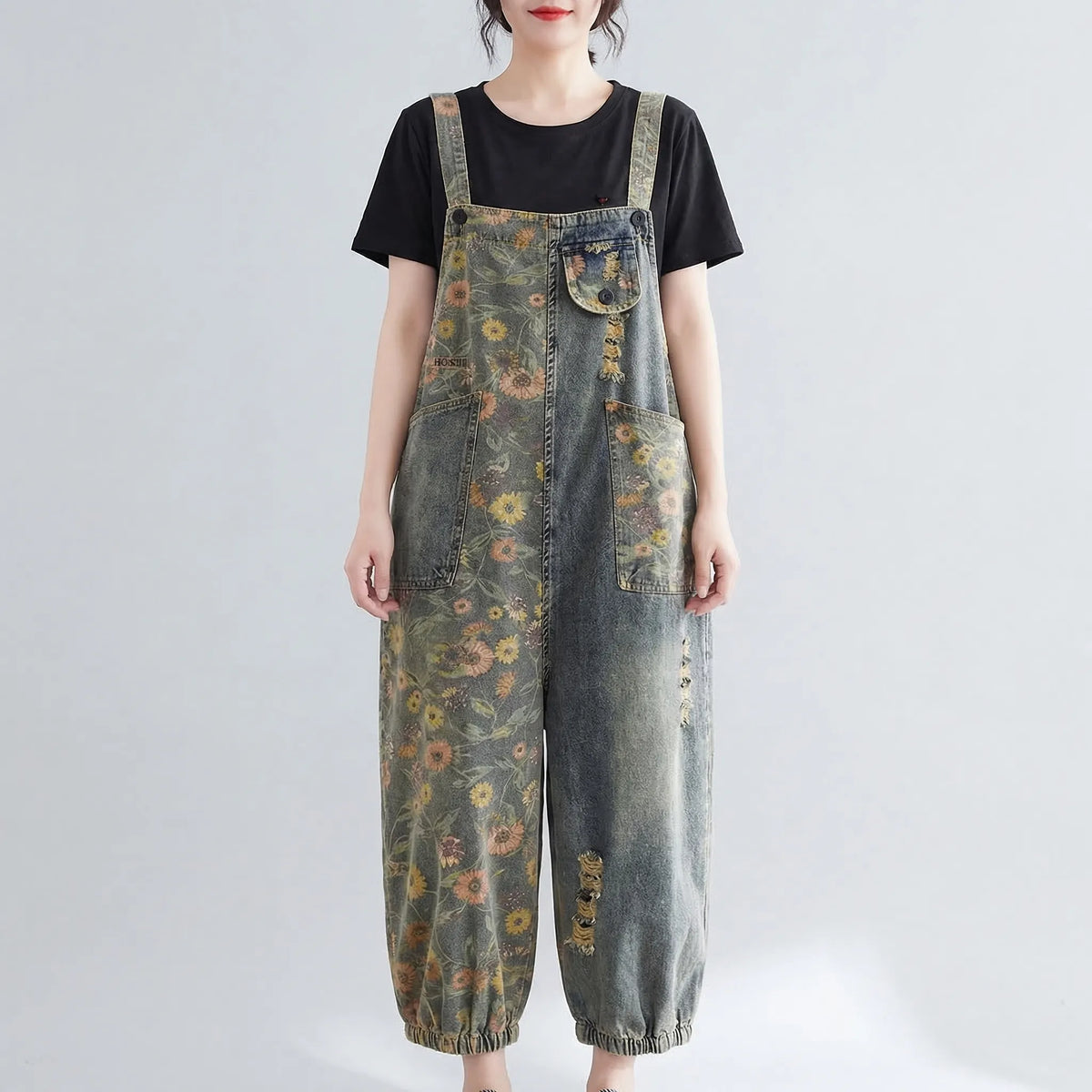 Denim dungaree with large-scale floral print and wide tapered leg