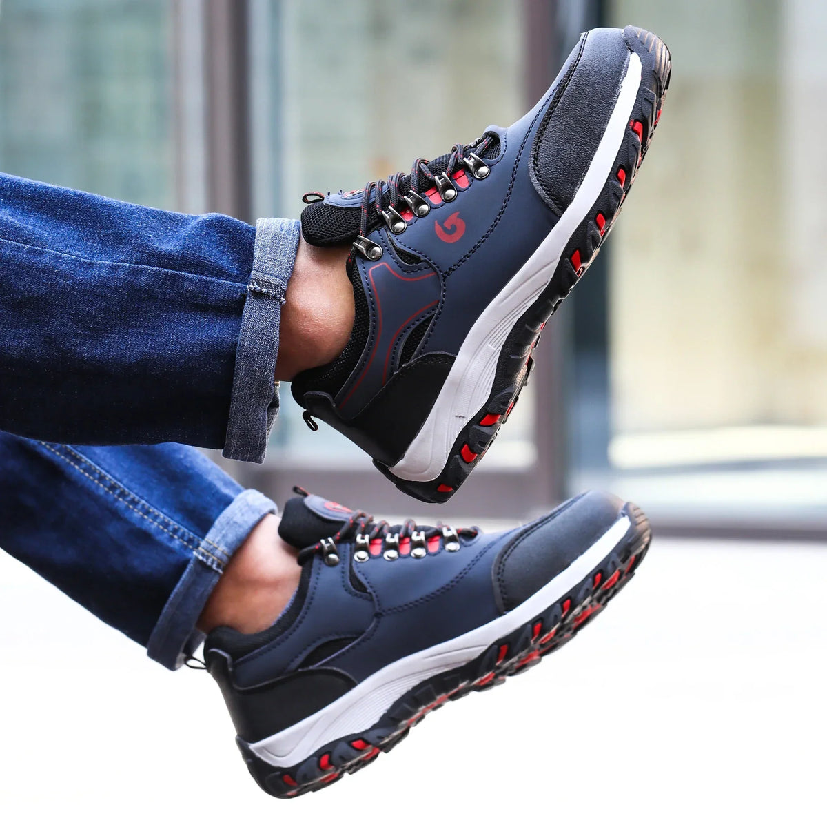 Low profile safety sneakers with reinforced toe protection and high traction sole