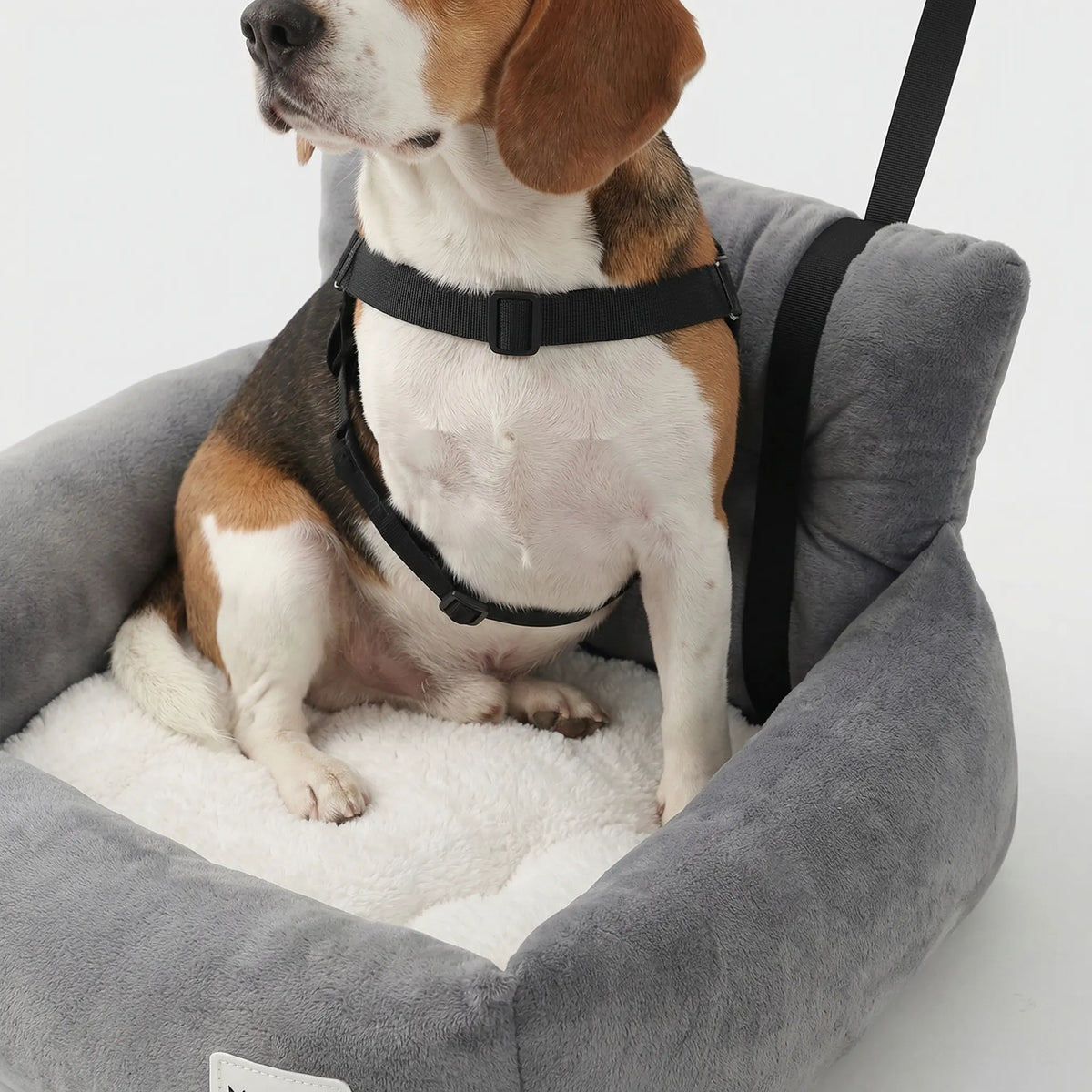 Padded pet car seat cushion with non-slip base and raised sides for secure car travel