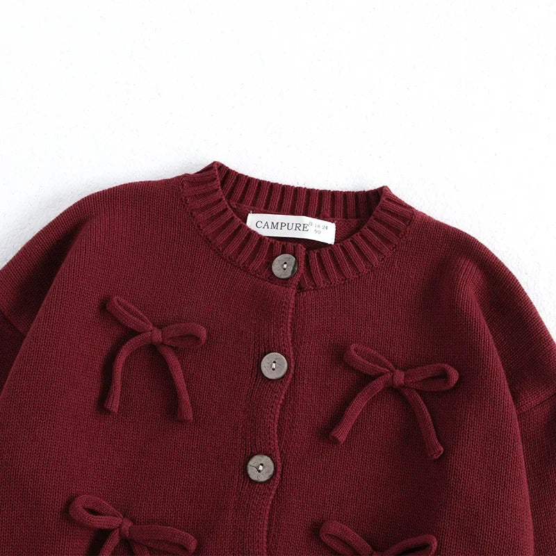 Girls knit cardigan with playful bows and ribbed details