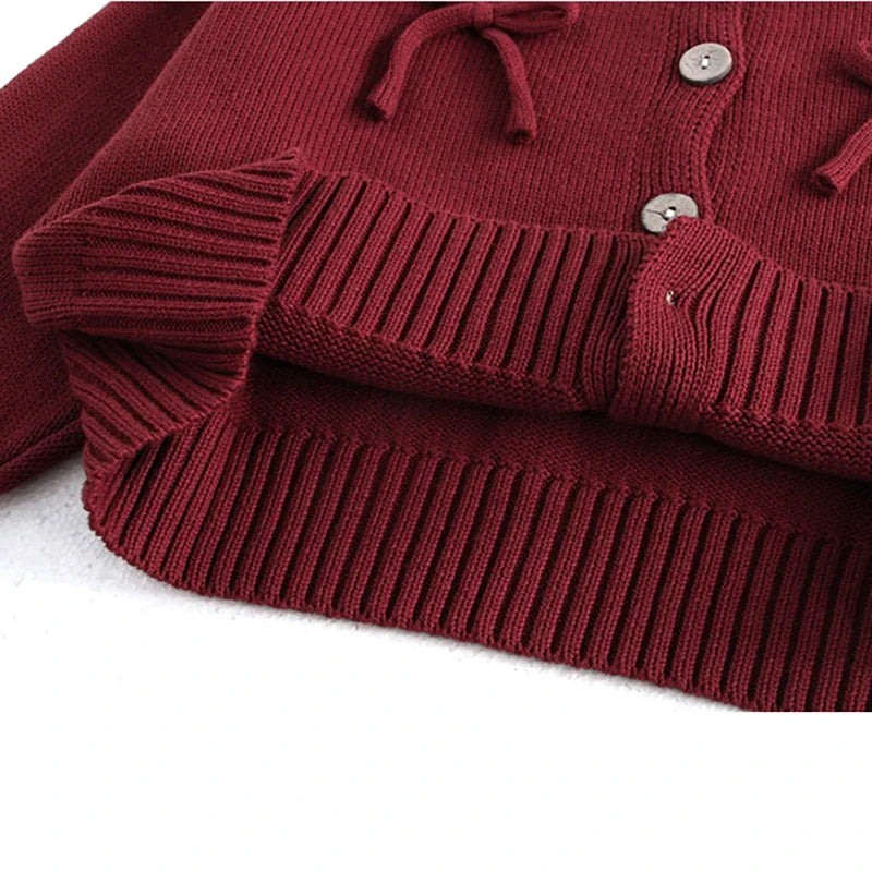 Girls knit cardigan with playful bows and ribbed details