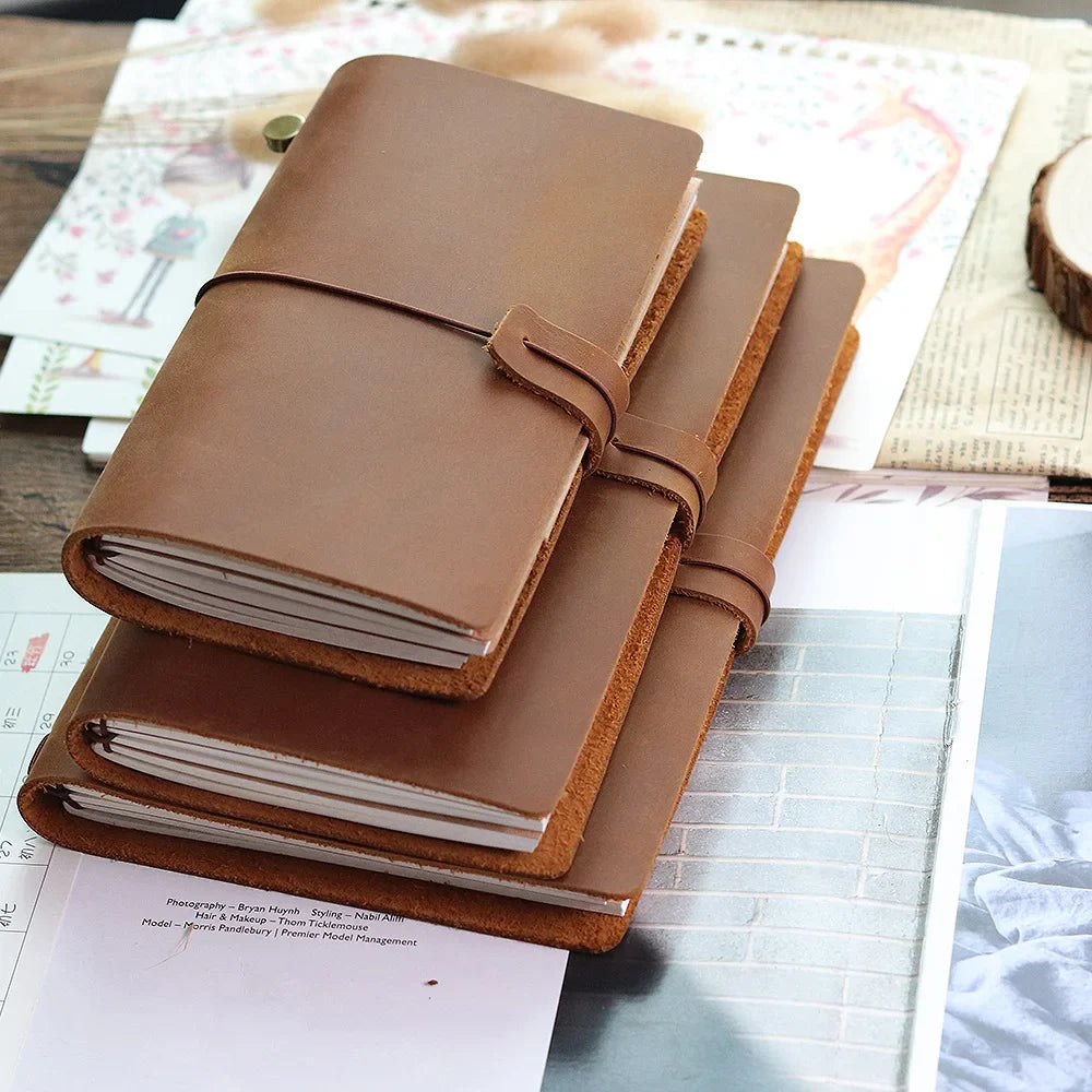 Refillable travel journal with retro handmade appearance and customisable charm accents