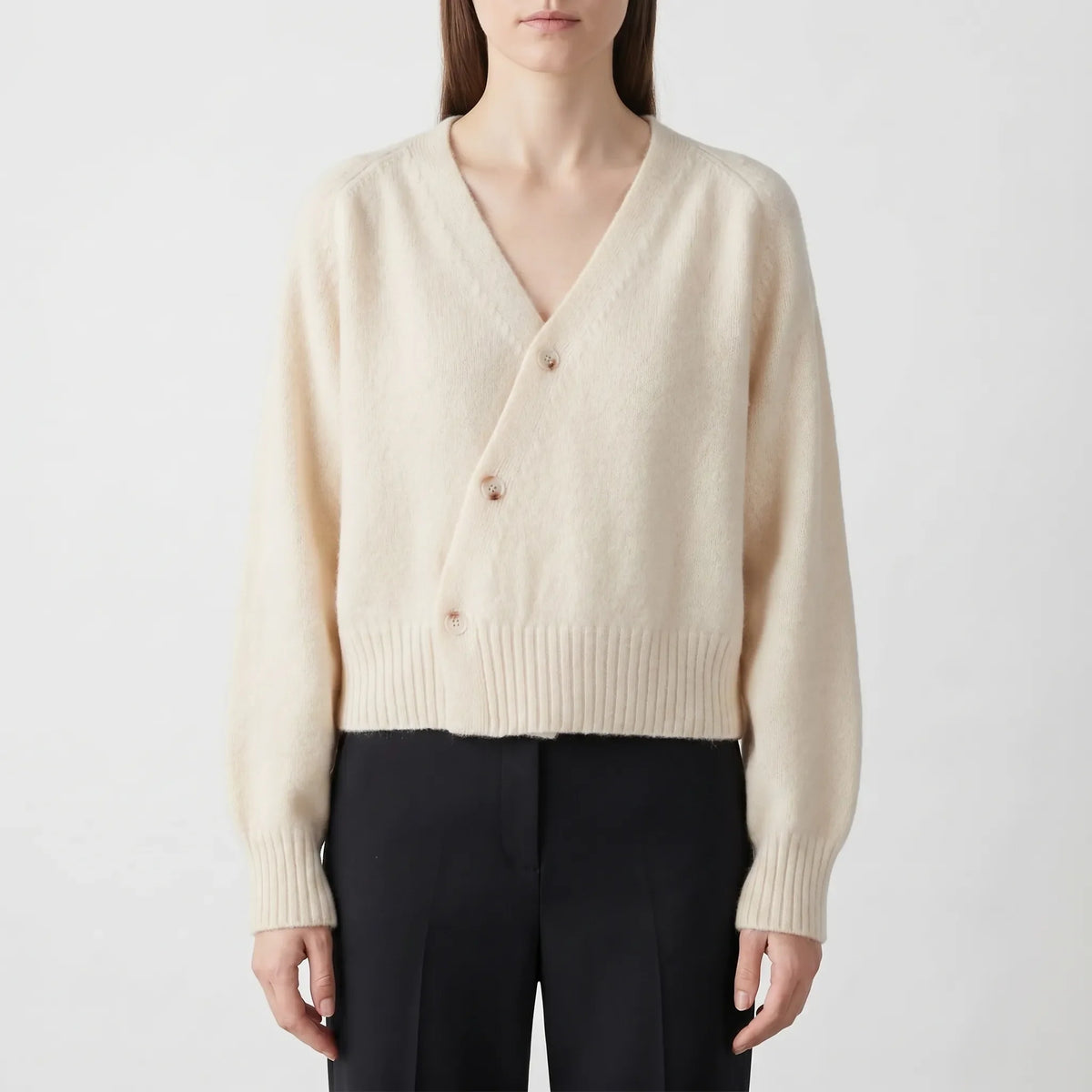 Women's asymmetrical knit cardigan with relaxed fit and cropped length