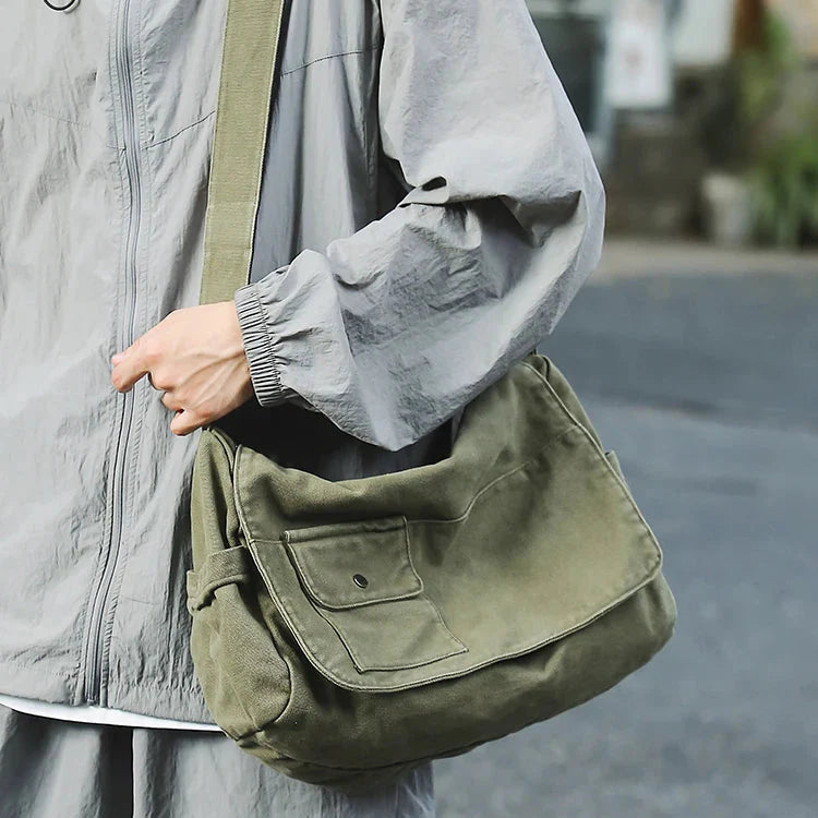Large canvas messenger bag with adjustable shoulder strap and secure zipper closure