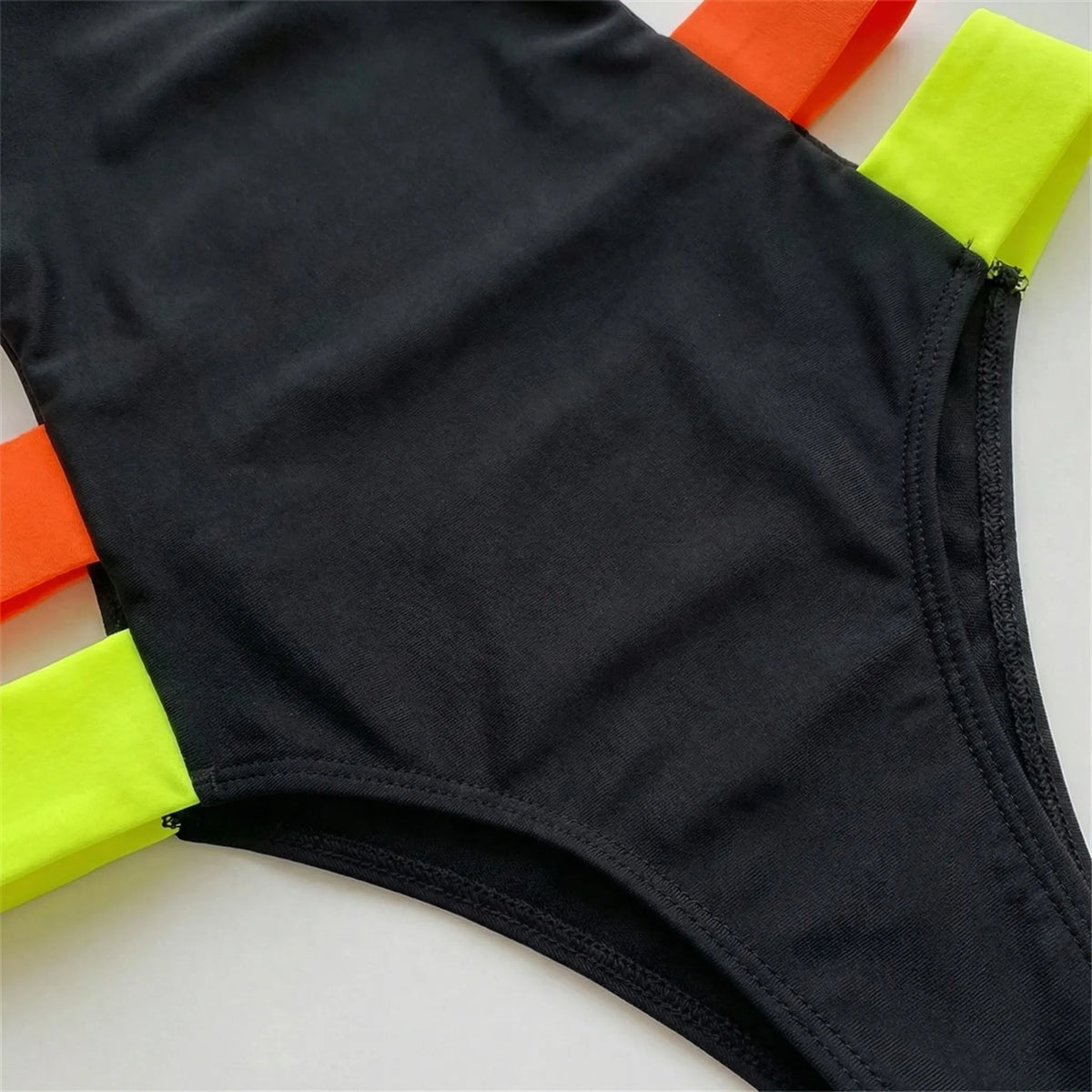 One-piece cutout swimsuit with neon contrast bands and wide supportive straps