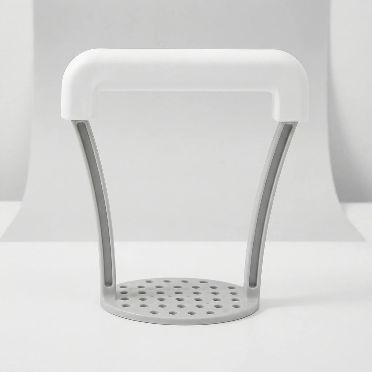 Potato ricer with non-slip grip and perforated press plate