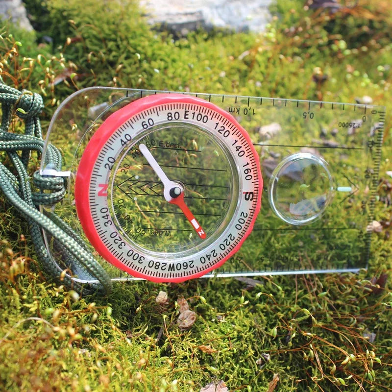 Baseplate field compass with luminous dial and map scales