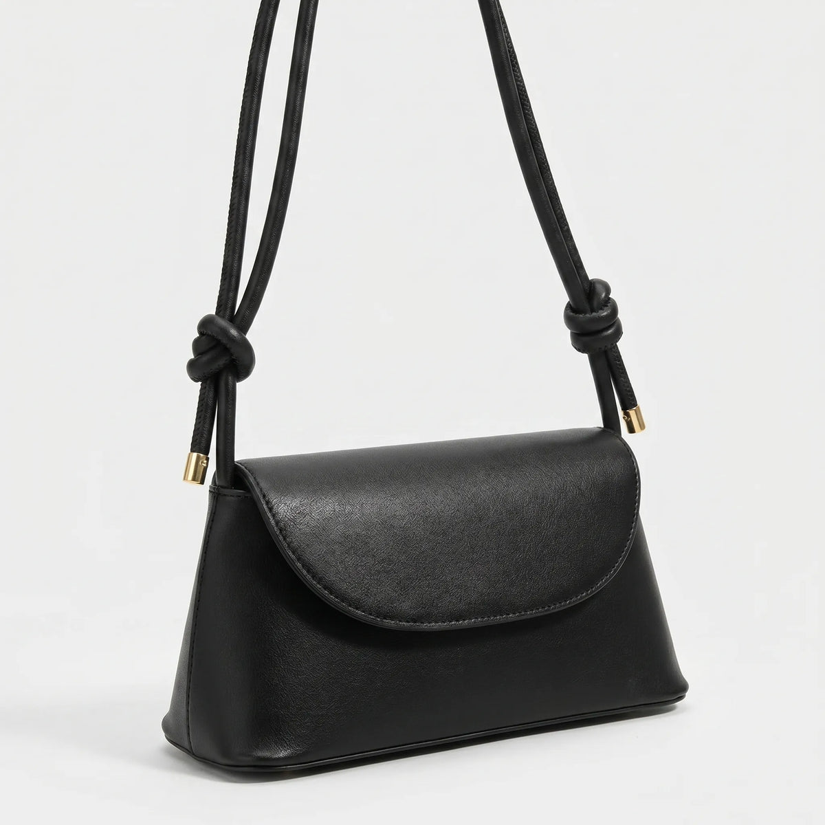 Compact square shoulder bag with knotted strap and flap closure
