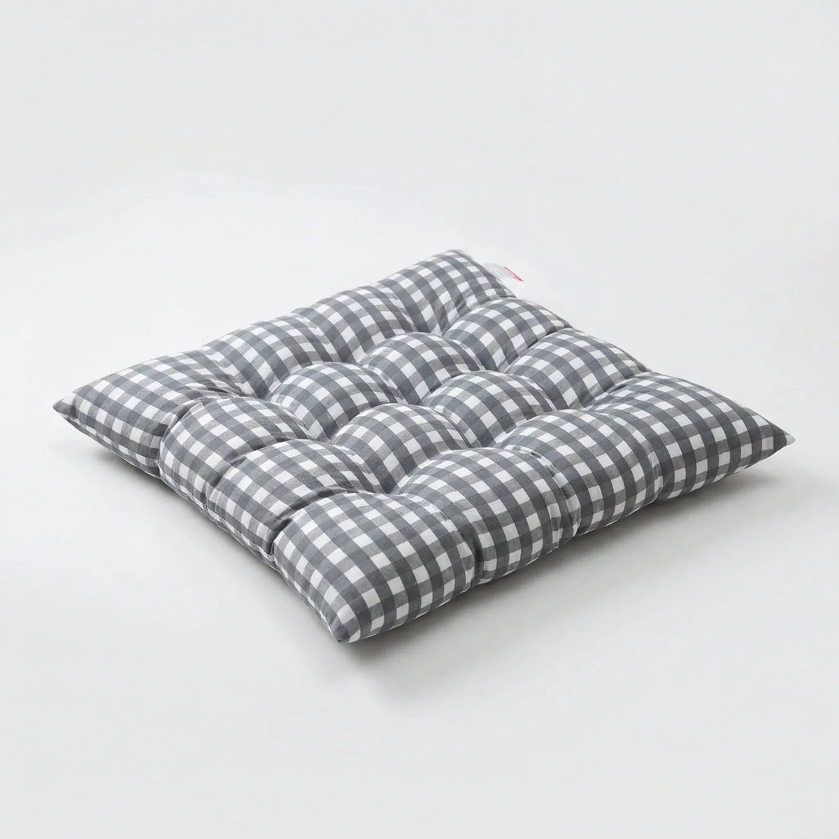 Square tufted chair pad with checkered pattern and attachment straps