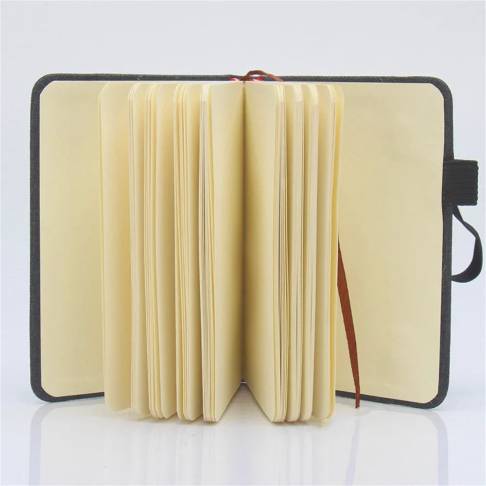 A7 portable coil notebook with blank pages and elastic closure