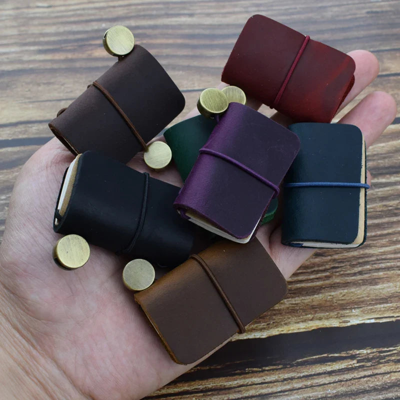 Mini pocket notebook with vintage-inspired design and secure wraparound closure