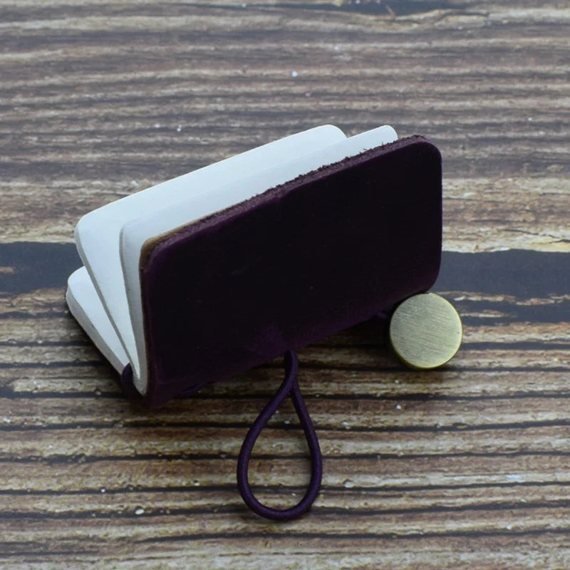 Mini pocket notebook with vintage-inspired design and secure wraparound closure