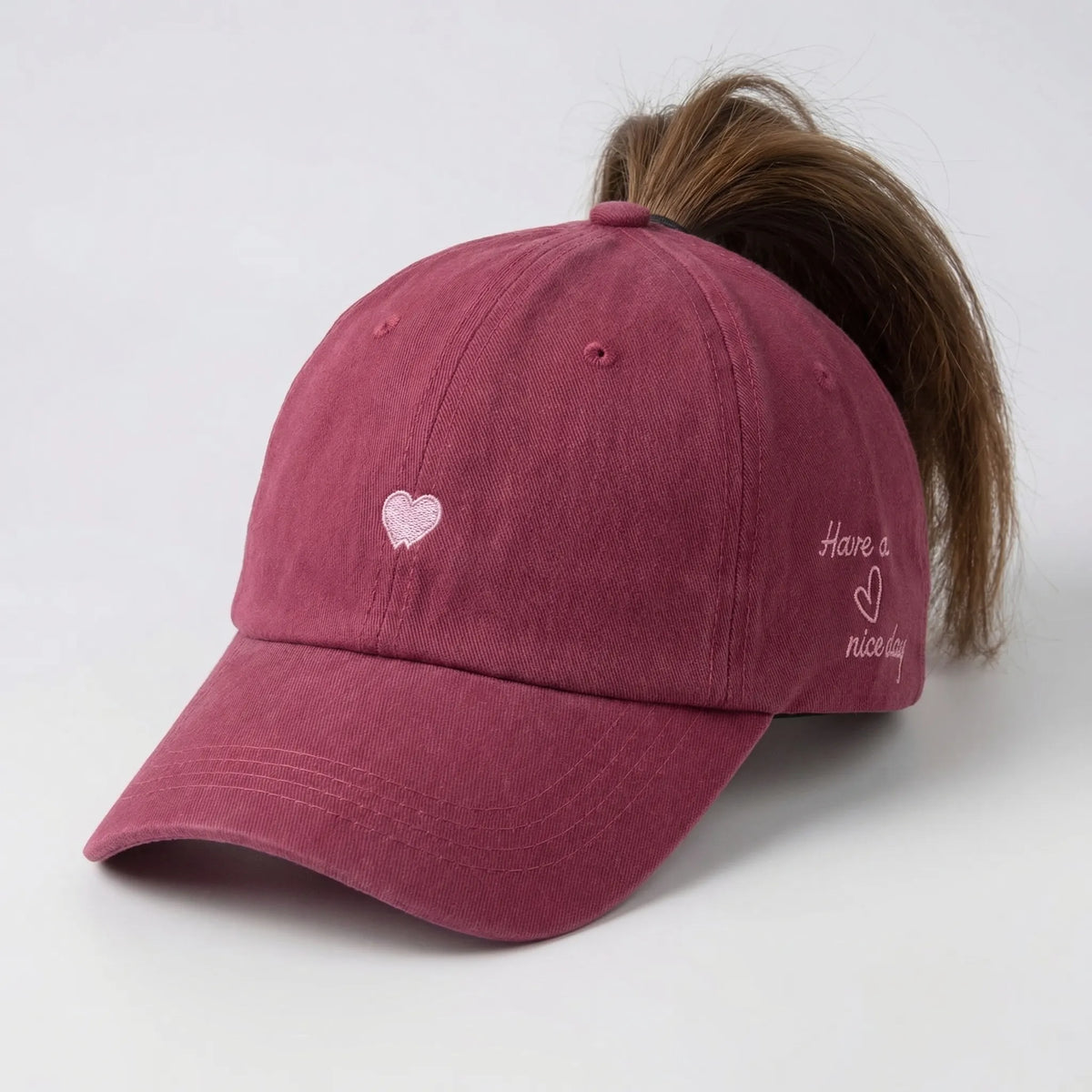 Women's ponytail baseball cap with open rear design and adjustable snapback