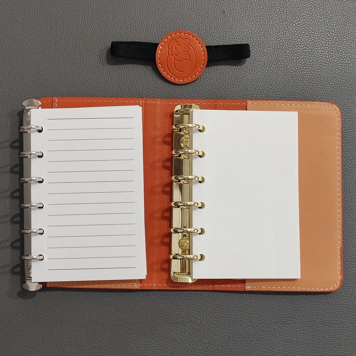 Compact A7 portable planner with detachable loose leaf pages and elastic closure