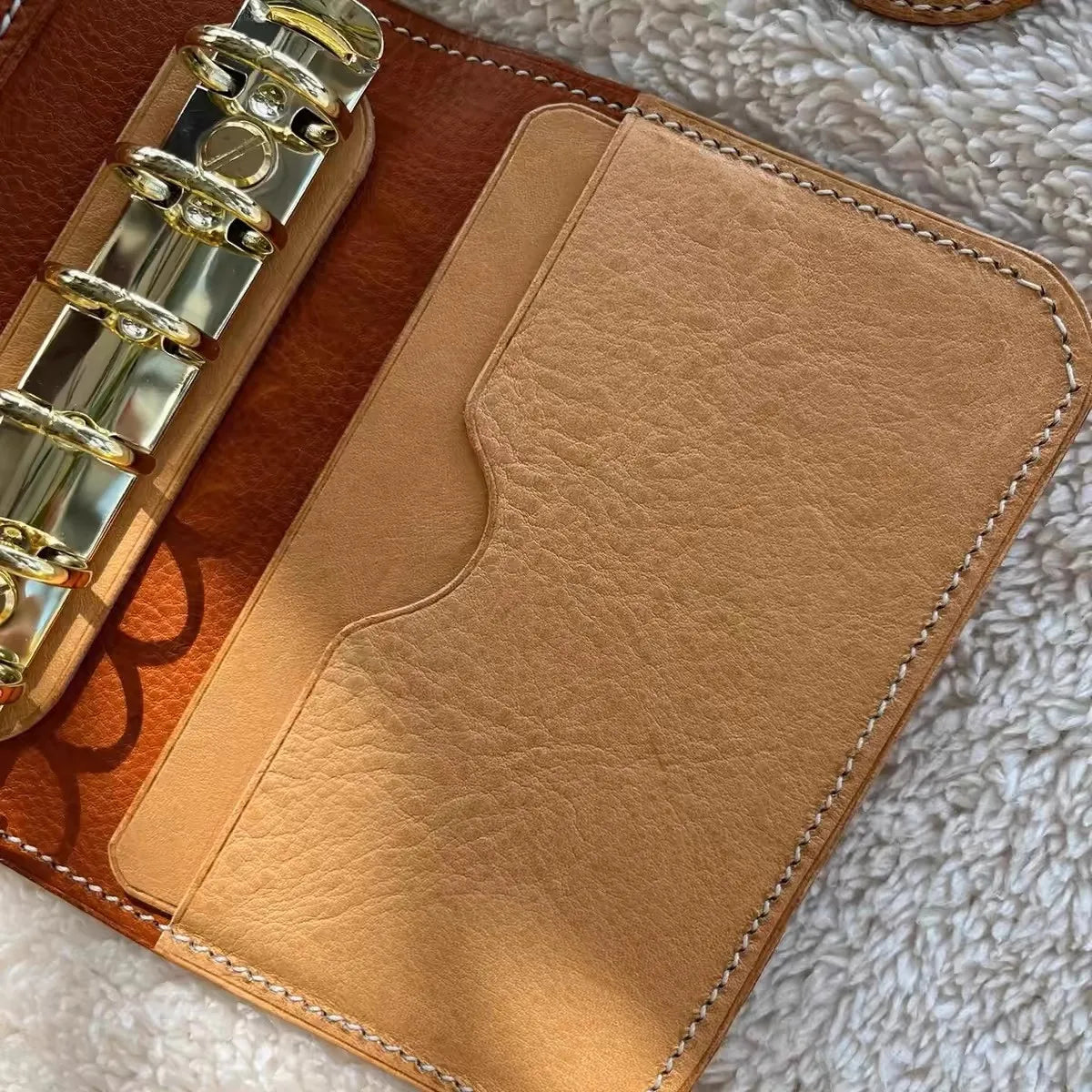 Compact A7 portable planner with detachable loose leaf pages and elastic closure