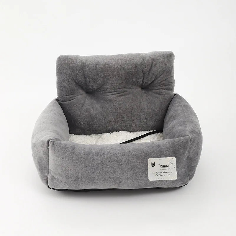 Padded pet car seat with raised backrest and non-slip underside