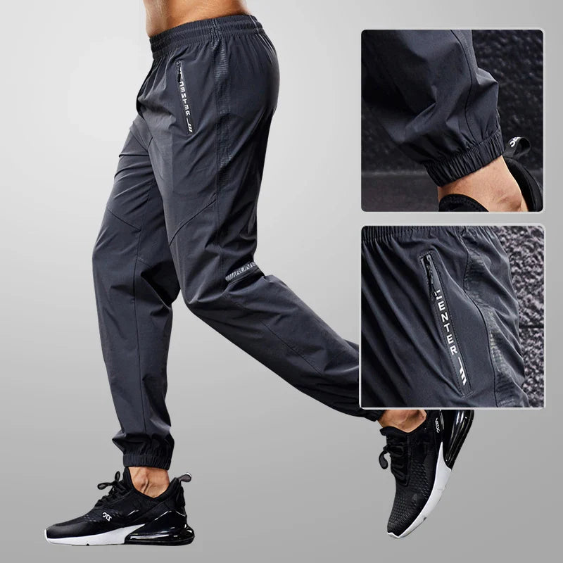 Men's quick drying running trousers with secure zip pockets and reflective accents